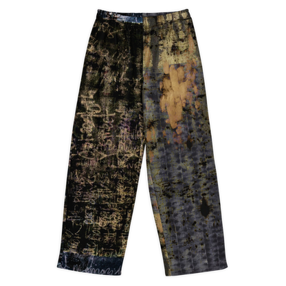 A pair of wide-leg cropped pants featuring a split design with one leg in black and gold abstract scribble print and the other in blue and gold abstract scribble print, set against a plain white background.