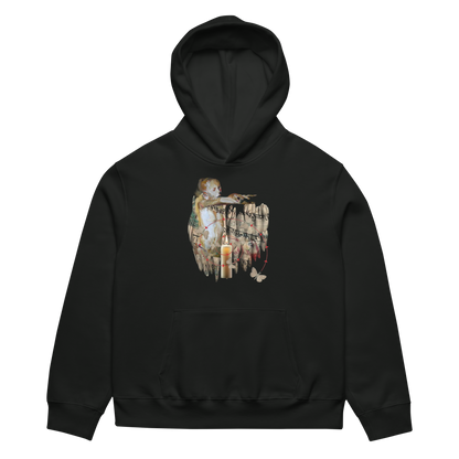 A black pullover hoodie with a detailed vintage-style graphic print on the chest depicting a cherub painting, candles, and butterflies, shown against a plain white background.