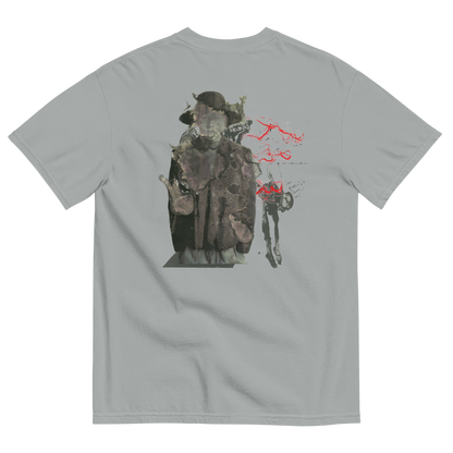 A light gray crewneck t-shirt shown from the back, featuring a large graphic print of a hooded figure in a dark coat with red spray-paint style markings.