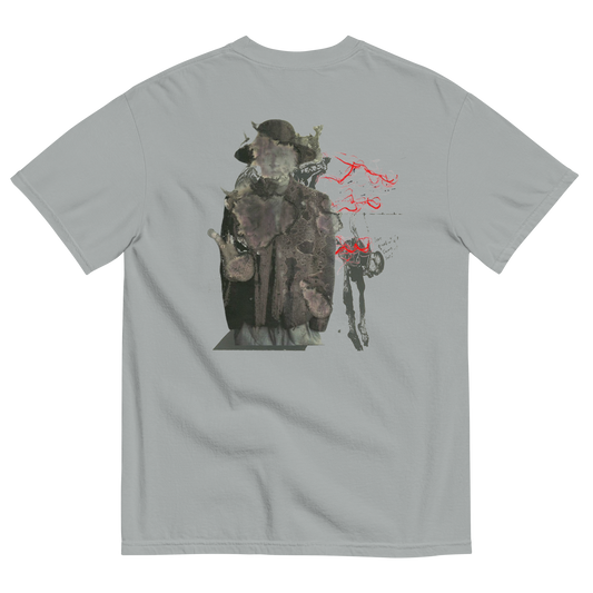 A light gray crewneck t-shirt shown from the back, featuring a large graphic print of a hooded figure in a dark coat with red spray-paint style markings.