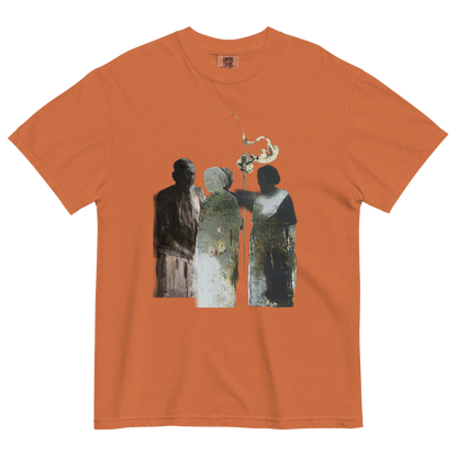 An orange crewneck t-shirt featuring a central graphic print of three stylized figures in muted green, gray, and black tones, with a small white bird above them.