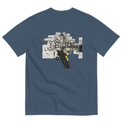 A blue-gray crewneck t-shirt shown from the back, featuring a graphic print with the text 'WAY THE BRIDGES ARE BURNT, LIGHT THE WAY' and an illustration of a black car with a yellow window on a white collage background.