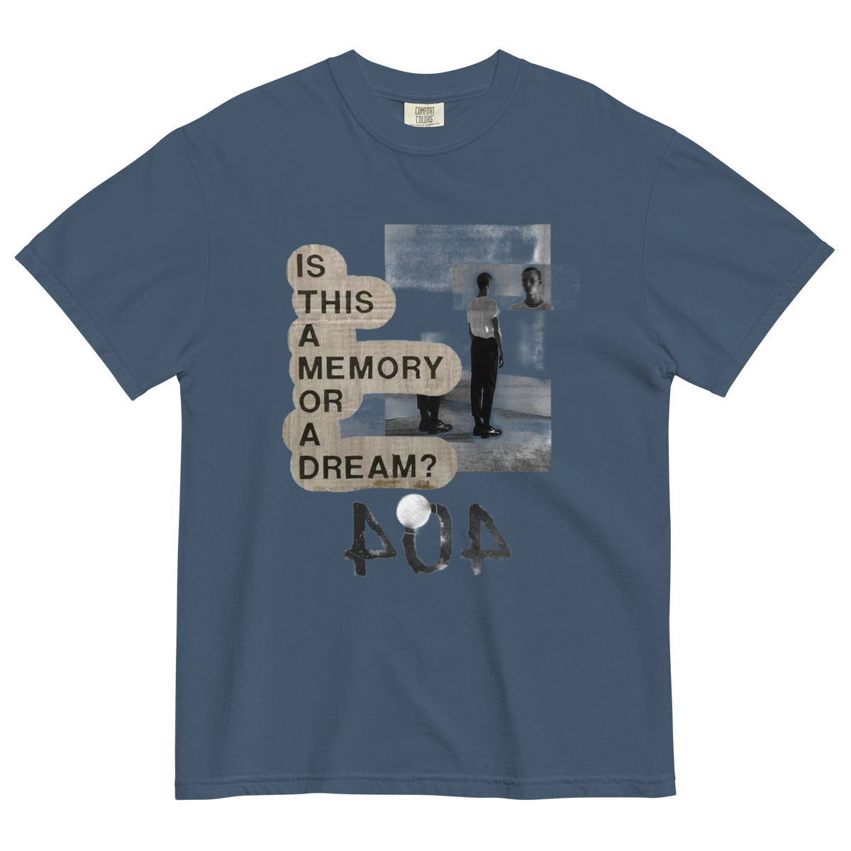 A slate blue crewneck t-shirt featuring a distressed graphic print with the text 'IS THIS A MEMORY OR A DREAM?' in beige speech bubbles, a black and white photo of a person in a room, and the word 'POA' in a textured font below.