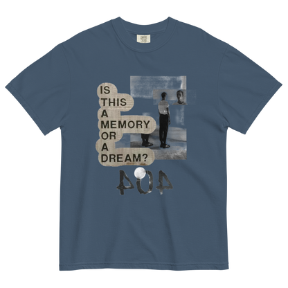A slate blue crewneck t-shirt featuring a distressed graphic print with the text 'IS THIS A MEMORY OR A DREAM?' in beige speech bubbles, a black and white photo of a person in a room, and the word 'POA' in a textured font below.