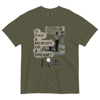 An olive green short-sleeve t-shirt with a distressed graphic print on the front. The graphic features the text 'IS THIS A MEMORY OR A DREAM?' in a beige typewriter font next to a black-and-white photo of a person, with '404' written below in a textured font.