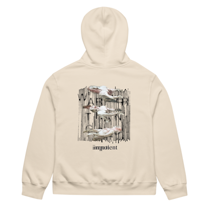 A cream-colored hoodie shown from the back, featuring a graphic print of four white pelicans against a black vertical brushstroke background, with the word 'impatient' printed below in black.