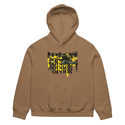 A brown pullover hoodie with a front kangaroo pocket and a central graphic print featuring a black and yellow crowd scene with the text 'CHICAGO CHICAGO ORDER'.